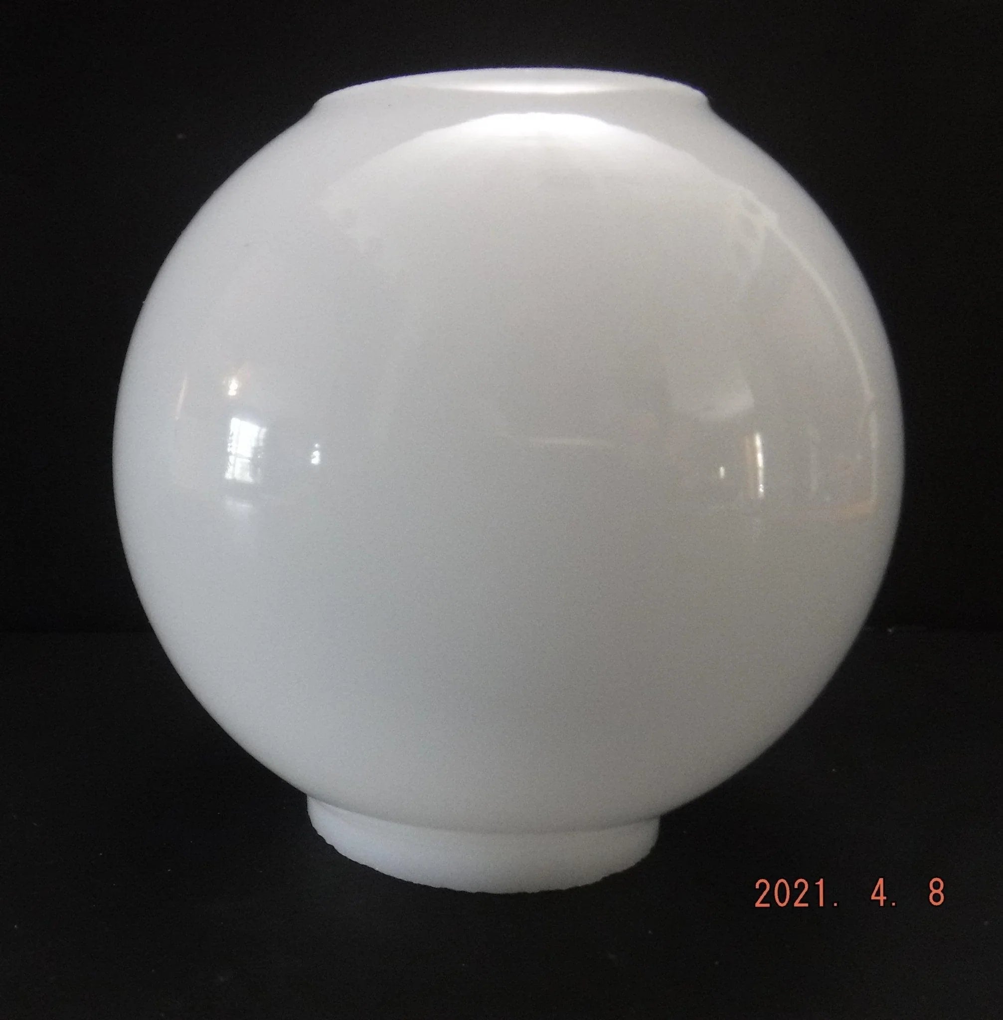 A smooth, round, white glass globe lampshade sits on a dark surface with a black background. The date "2021. 4. 8" is visible in the bottom right corner.